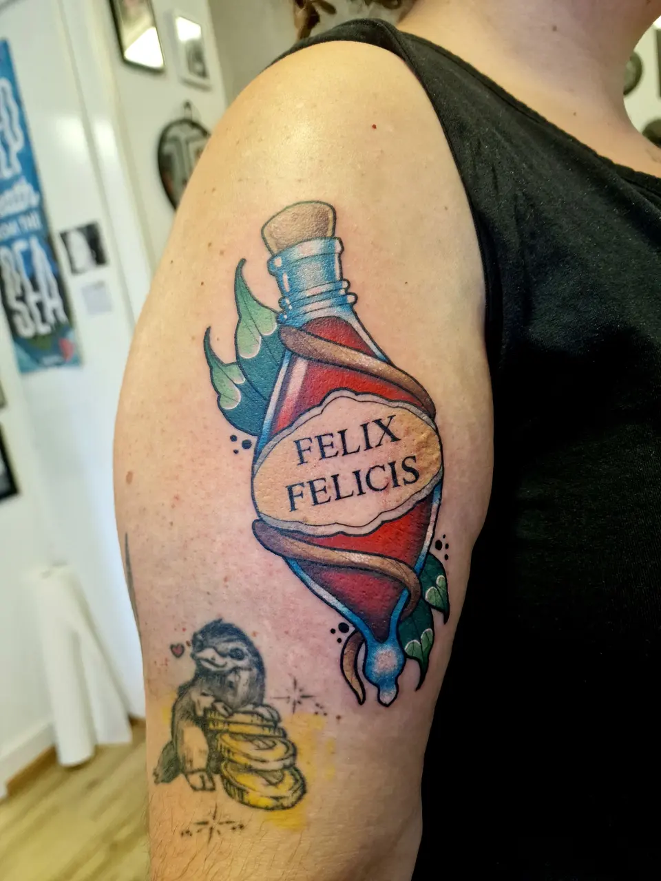 Fiole de potion « Felix Felicis » tatouée sur le bras