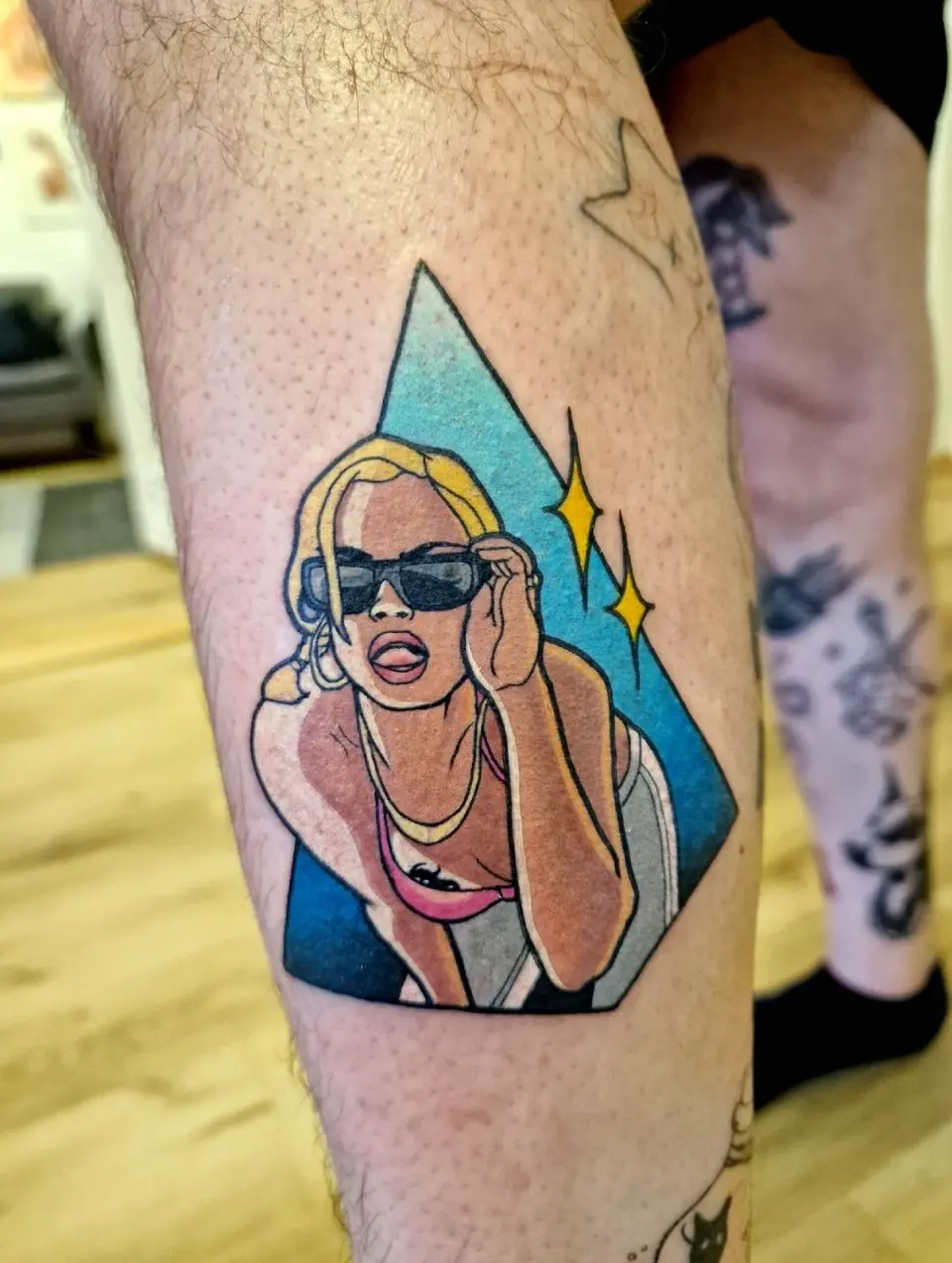 Femme aux lunettes de soleil dans un triangle bleu, sur le mollet